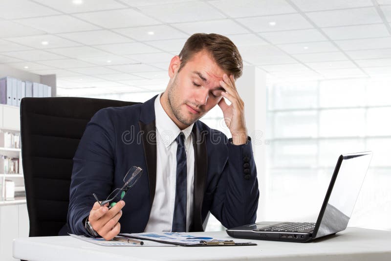 Young businessman having headache, stressed with his work stock image Young businessman having headache, stressed with his work stock image
