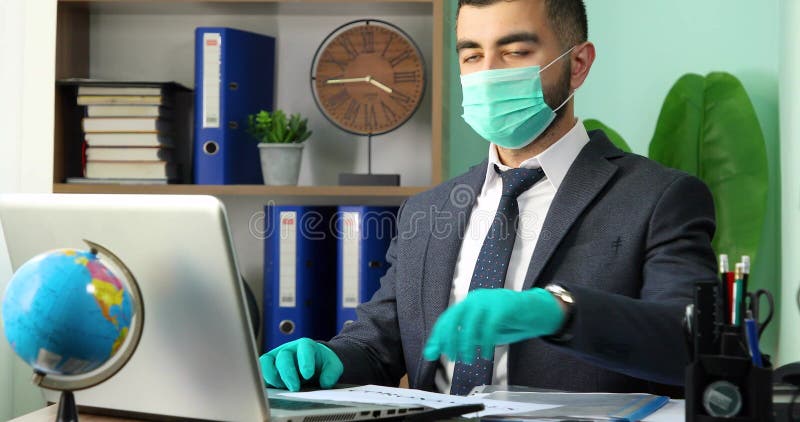 Young businessman holding Coronavirus word