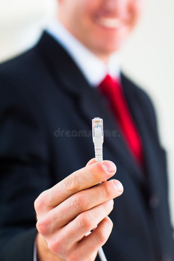 Young businessman holding an ethernet cable