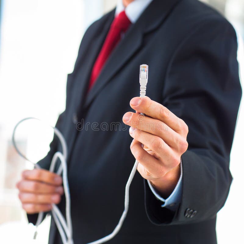 Young businessman holding an ethernet cable