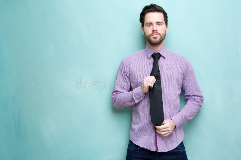 Young businessman holding necktie stock image Young businessman holding necktie stock image