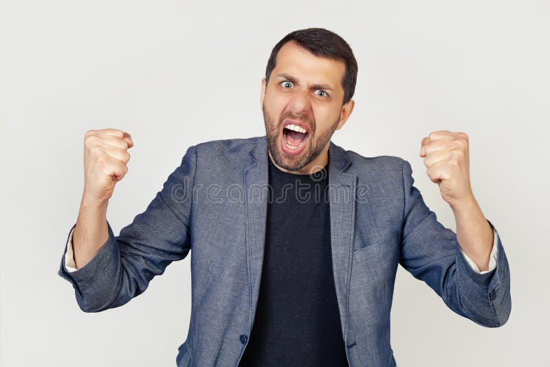 Young Businessman Man With A Beard Angry And Insane Raising His Fists