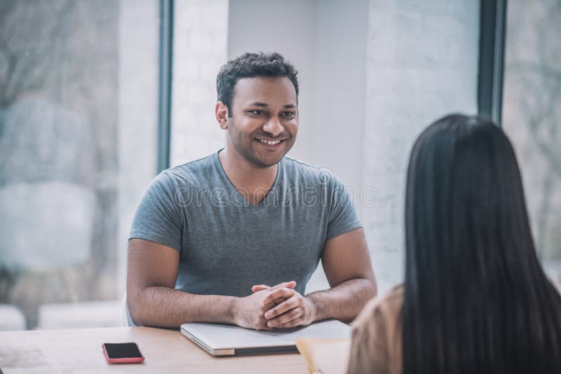 A young businessman meeting a female client royalty free stock photography