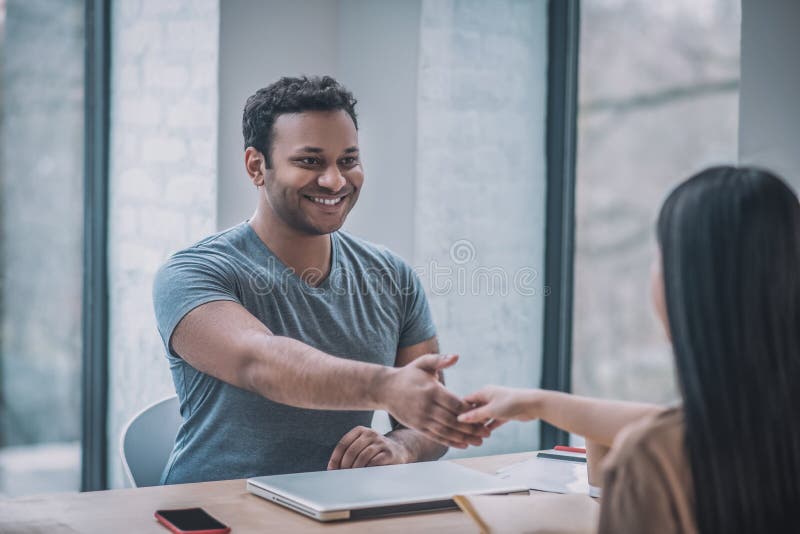 A young businessman meeting a female client royalty free stock photography