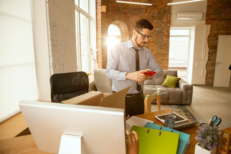 A young businessman moving in office, getting new work place royalty free stock photo A young businessman moving in office, getting new work place royalty free stock photo