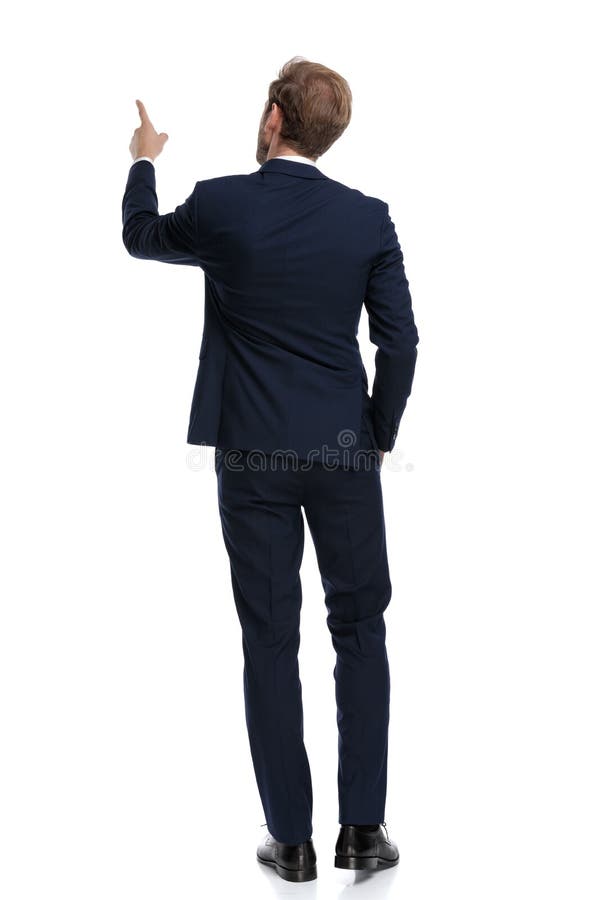 Young businessman in navy blue suit pointing finger up