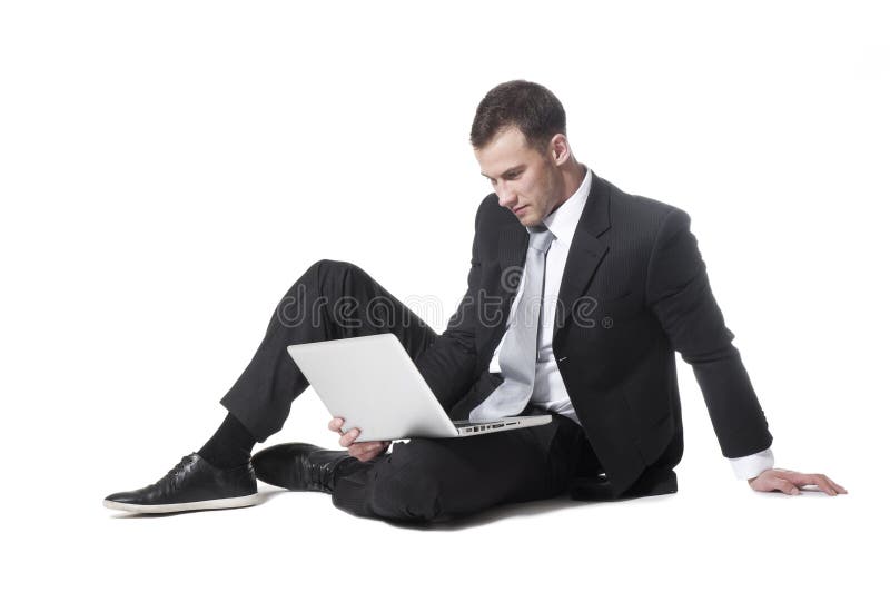 Young businessman sitting with laptop