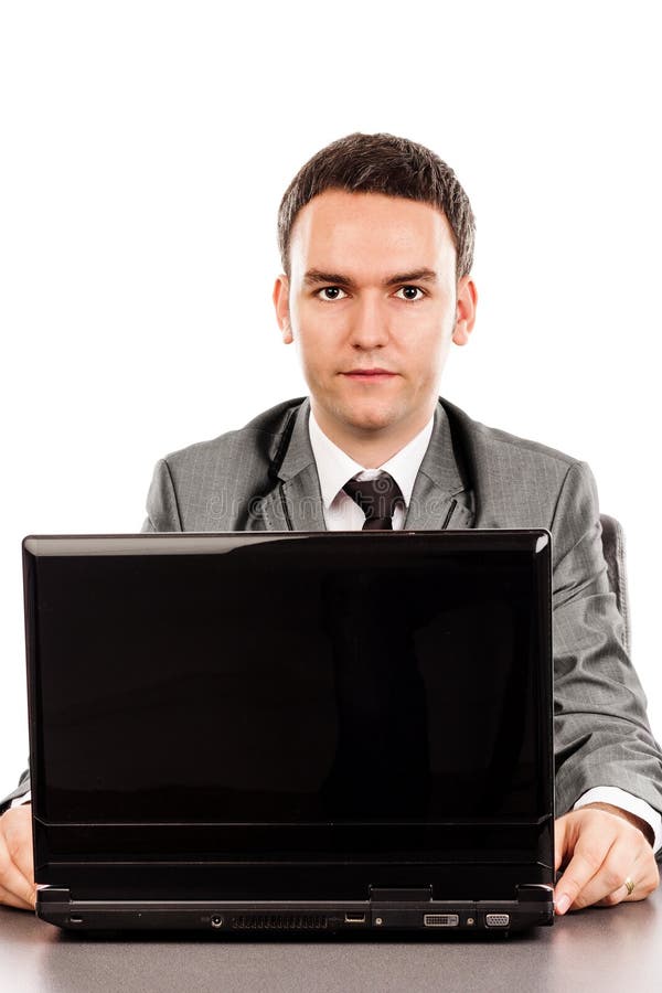 Young Businessman Sitting At Office Desk And Looking At Camera Stock