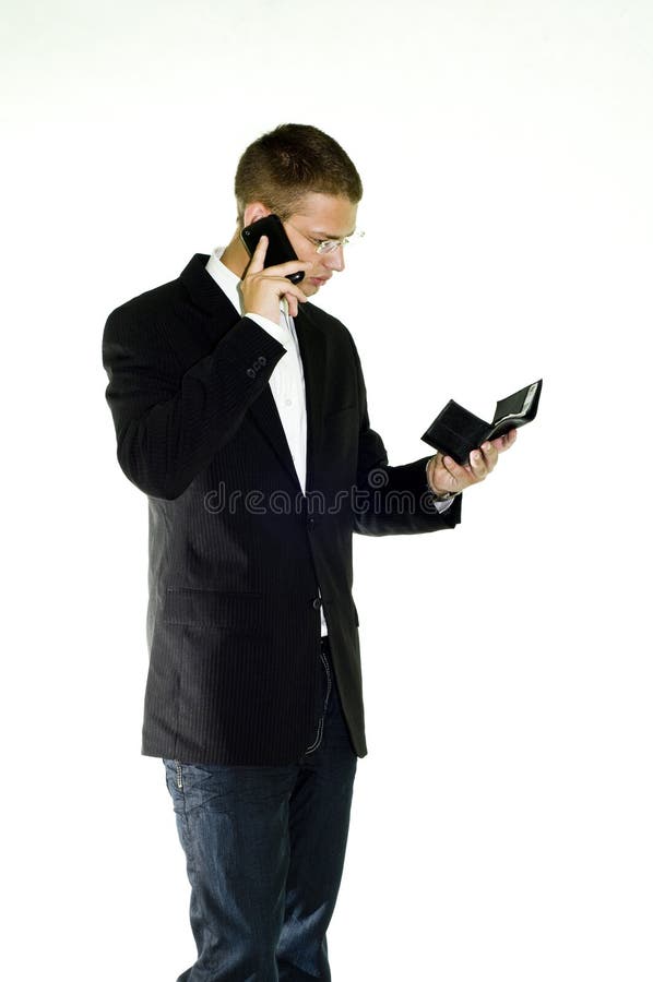 Young businessman talking on mobile holding wallet