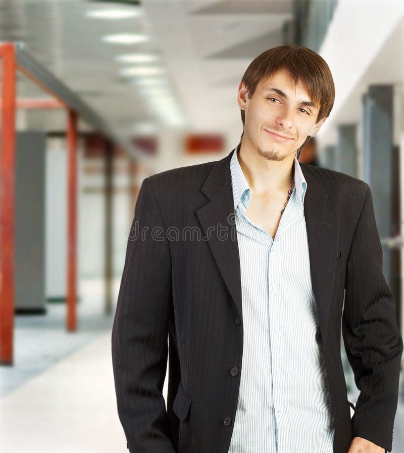 Young businessman walking in a corridor