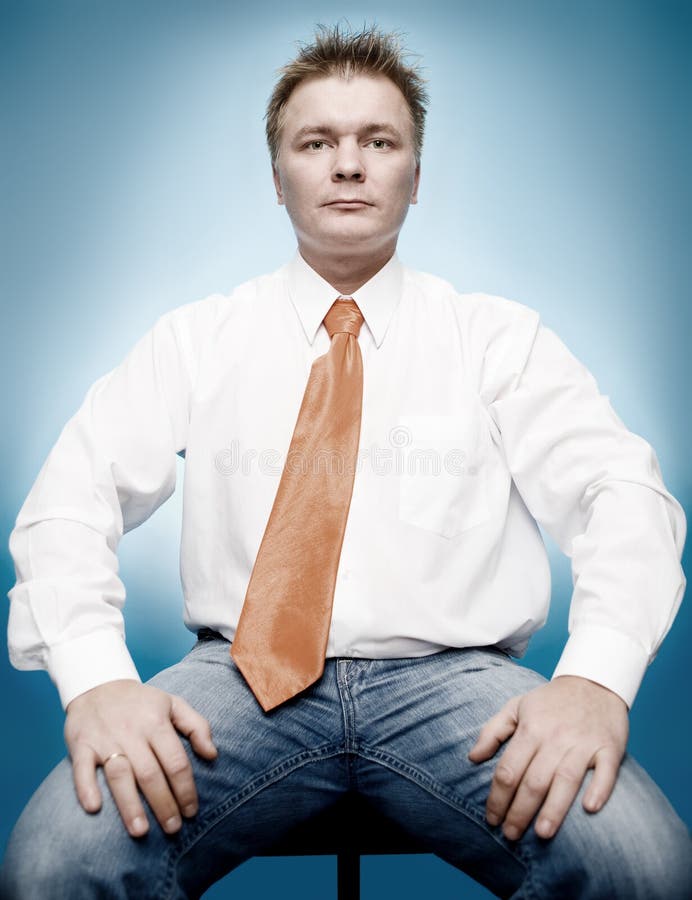 Young businessman in white shirt and orange tie