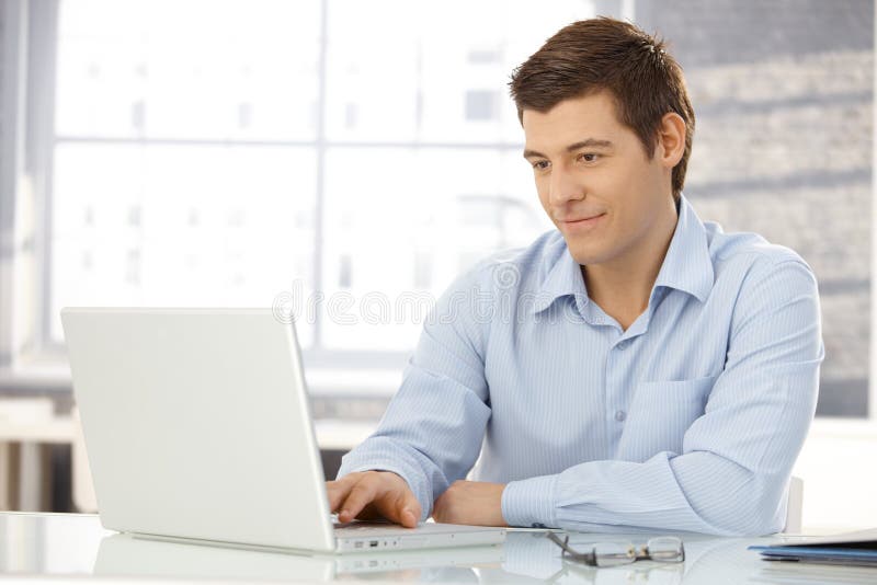 Young businessman working in office royalty free stock image