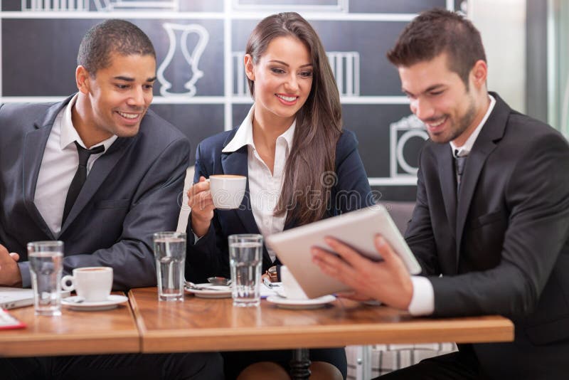 Young businesspeople having a business meeting at coffee table