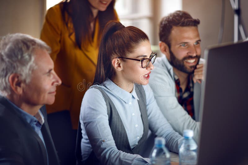 Businesspeople with male manager working in design studio royalty free stock photo
