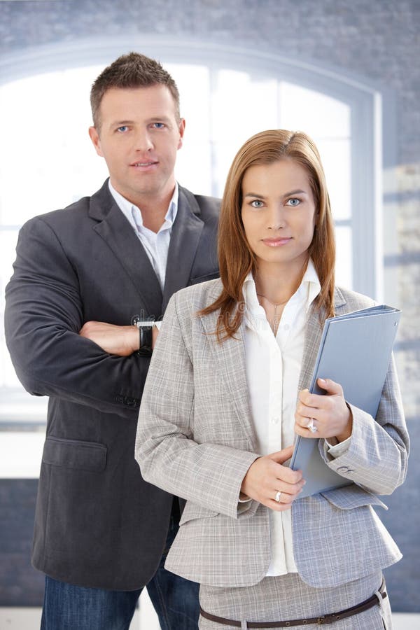 Young businesspeople standing in office