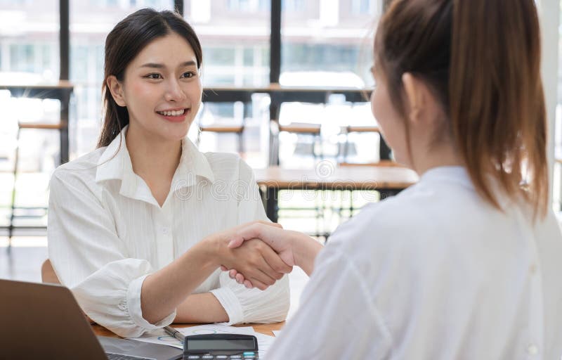 Young Businesswoman Collaborating with Colleague in Modern Office Setting, Engaging in Productive Discussion and royalty free stock photo