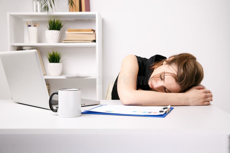 Young Businesswoman Feeling Sleepy At Her Work Place In Office