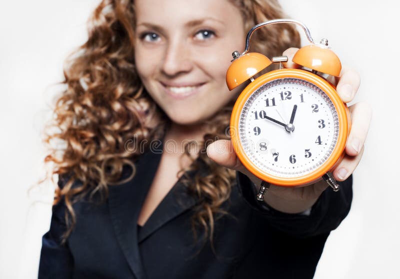 Young businesswoman holding a clock