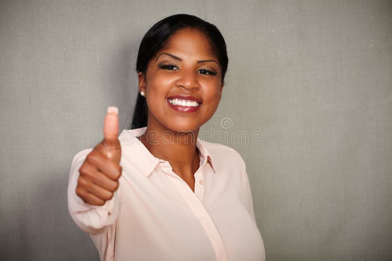Young businesswoman making a good job gesture royalty free stock photo Young businesswoman making a good job gesture royalty free stock photo