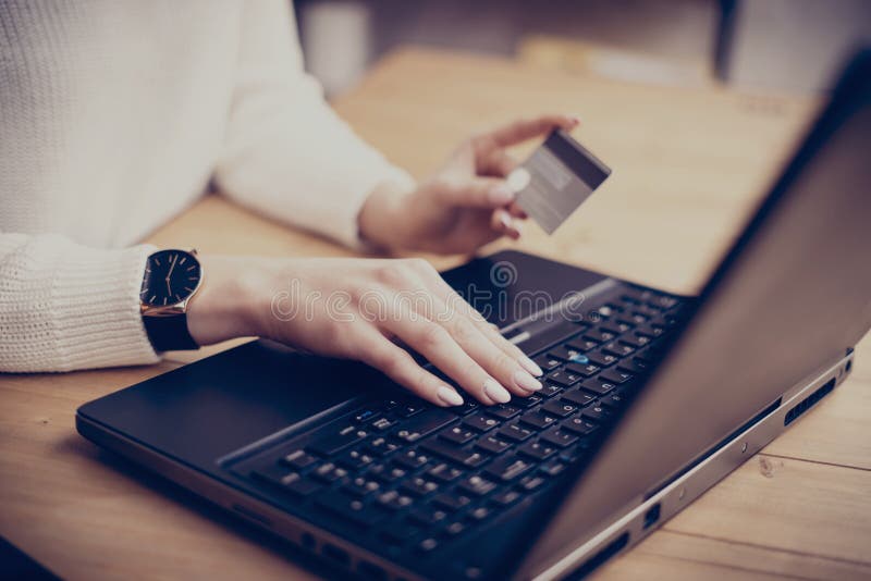 Young businesswoman making online shopping via laptop, typing on keyboard and using her credit card. Horizontal, film stock images Young businesswoman making online shopping via laptop, typing on keyboard and using her credit card. Horizontal, film stock images
