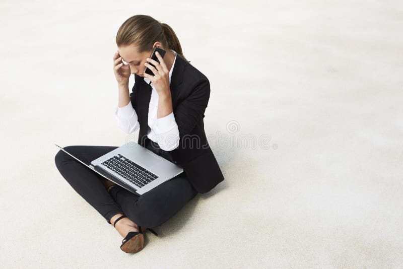 Young businesswoman sitting on floor