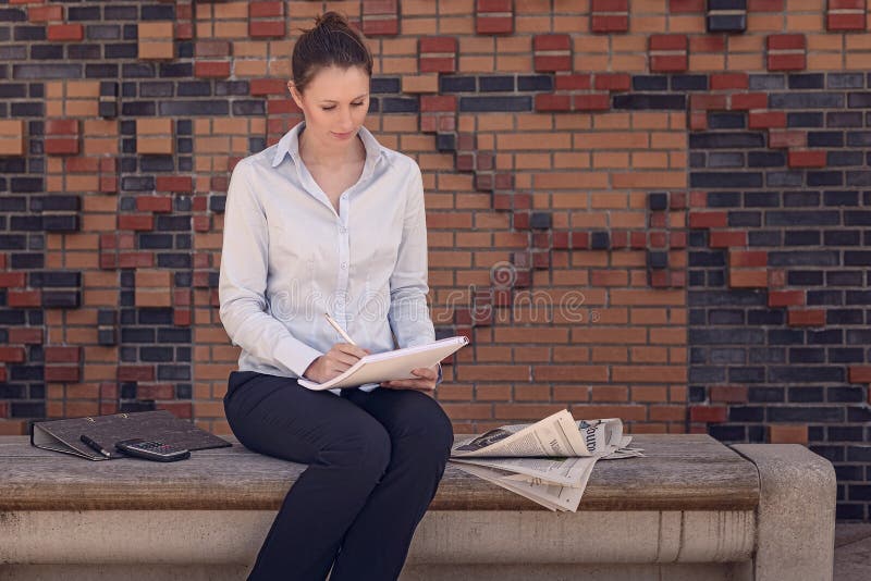 Young businesswoman sitting in a foyer stock images Young businesswoman sitting in a foyer stock images