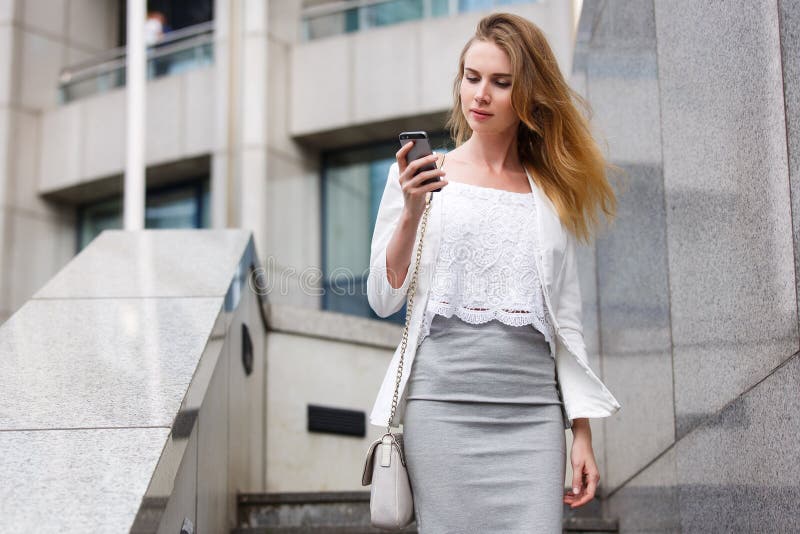 Young businesswoman talking on cellphone while walking outdoor royalty free stock image Young businesswoman talking on cellphone while walking outdoor royalty free stock image