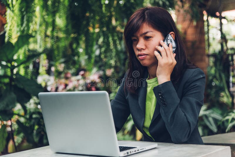 Young businesswoman talking on mobile smart phone with his client. royalty free stock photography Young businesswoman talking on mobile smart phone with his client. royalty free stock photography