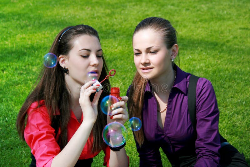 Young businesswomen blowing soap bubbles