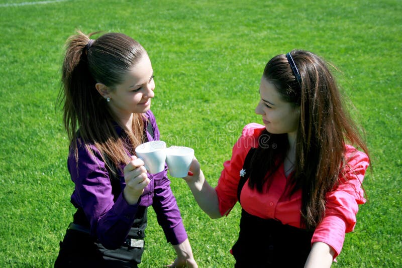 Young businesswomen drinking tea and talking