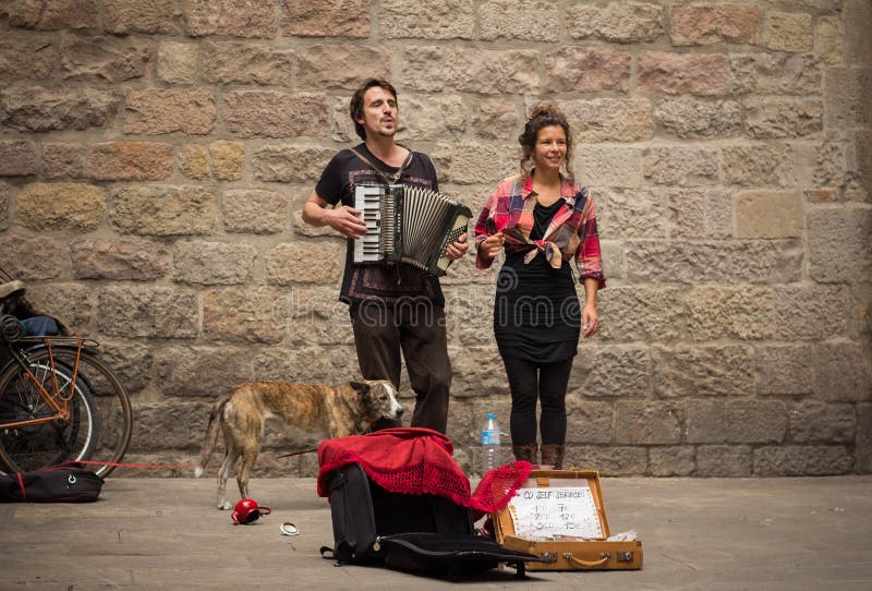 Young buskers with dog playing music royalty free stock images Young buskers with dog playing music royalty free stock images