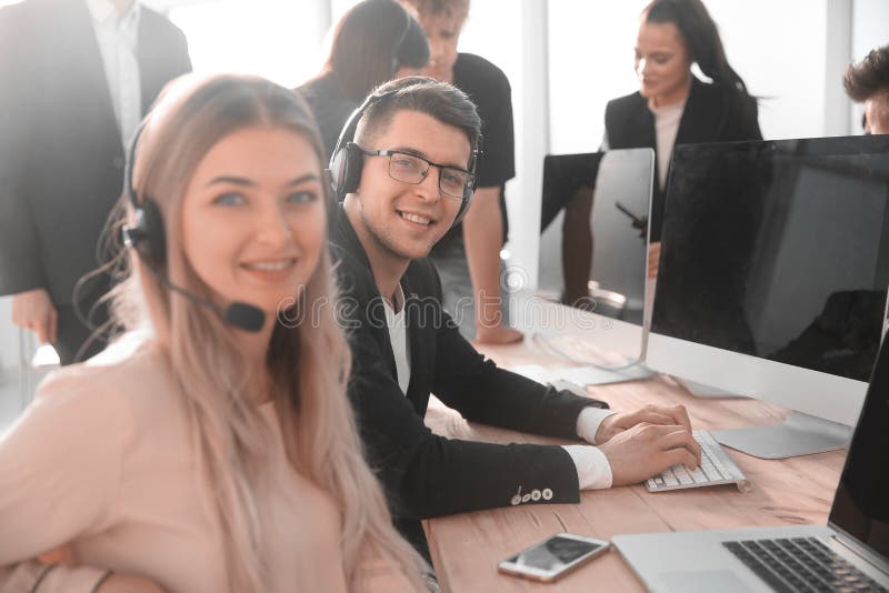 Young call center consultant sitting at his Desk royalty free stock photo Young call center consultant sitting at his Desk royalty free stock photo