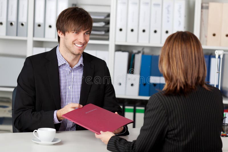 Young Candidate Looking At Businesswoman Taking Interview stock photography