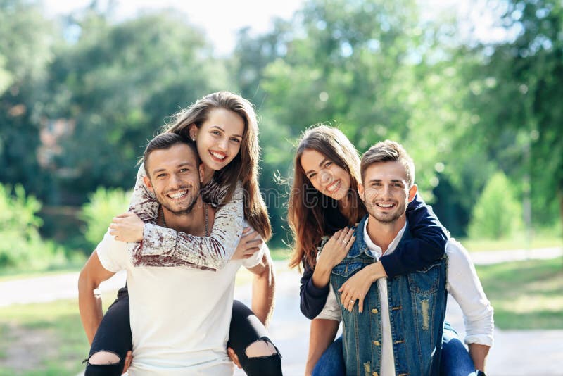 Young carefree friends women and men in double date outdoors royalty free stock images Young carefree friends women and men in double date outdoors royalty free stock images