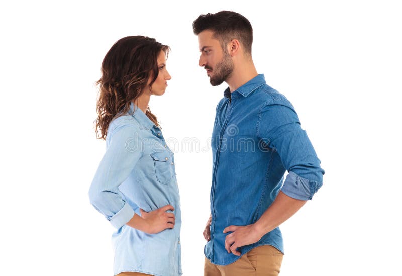 Young casual couple facing each other making funny faces