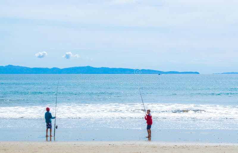 2 young boys fishing at the beach
