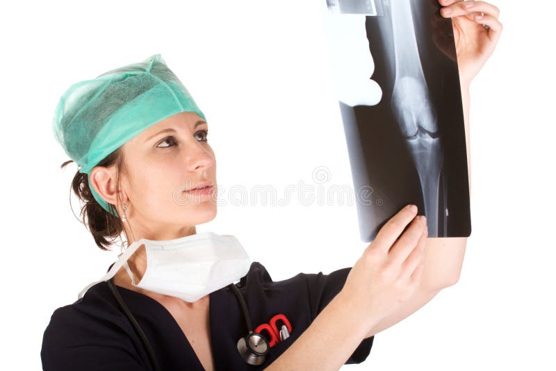 Young Caucasian female doctor examining an x-ray stock image Young Caucasian female doctor examining an x-ray stock image