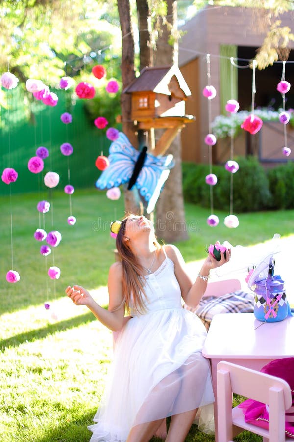 Young caucasian girl playing with decorations for summer camp. stock images