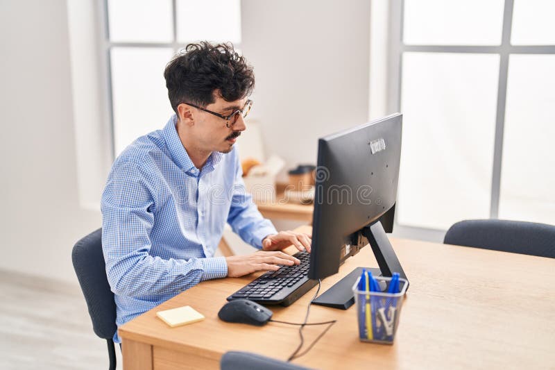 Young caucasian man business worker using computer working at office stock photo