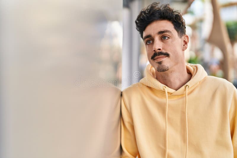 Young caucasian man looking to the side with serious expression at street royalty free stock image