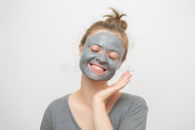 Young caucasian woman with black or grey facial clay mask on her face, smiling stock photography Young caucasian woman with black or grey facial clay mask on her face, smiling stock photography