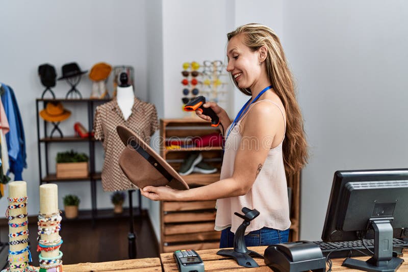 Young Caucasian Woman Shopkeeper Scanning Hat Using Barcode Reader at