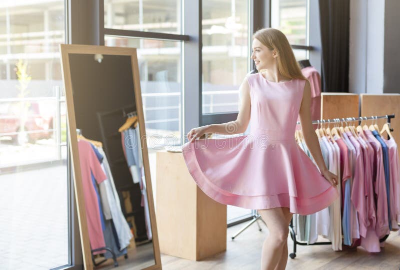 Pretty Young Woman Trying Pink Dress in ...