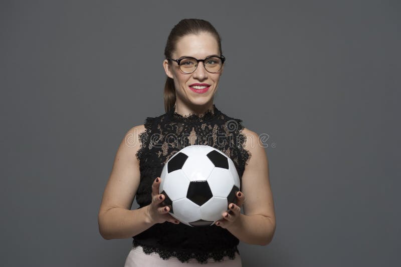 Young charming businesswoman - football fan holding soccer ball royalty free stock images Young charming businesswoman - football fan holding soccer ball royalty free stock images