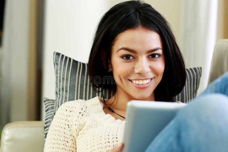 Young cheerful woman resting with tablet computer stock images