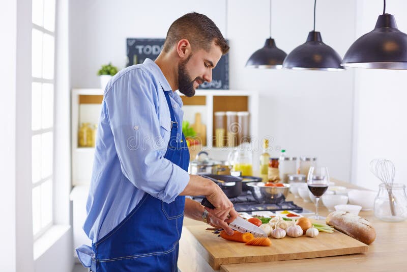 Young chef prepares a man in the kitchen stock photography Young chef prepares a man in the kitchen stock photography