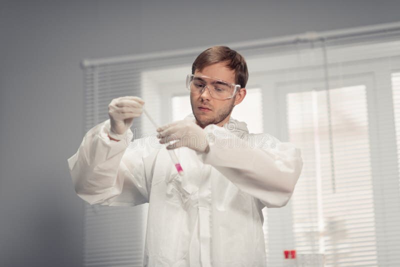 A young chemical engineer working at the chemistry laboratory stock photography