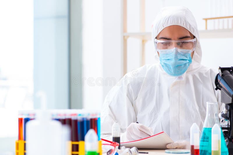 The Young Chemist Student Working in Lab on Chemicals Stock Photo