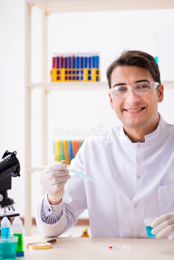 The Young Chemist Student Working in Lab on Chemicals Stock Image