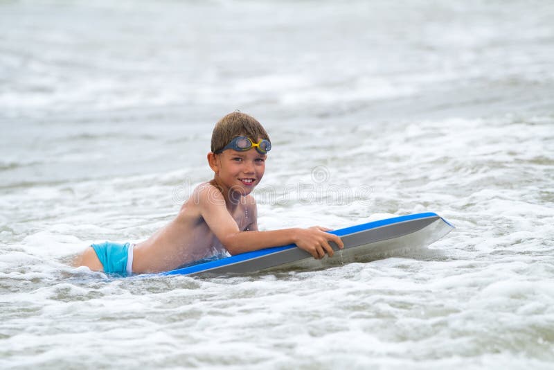 Young child with a bodyboard on the beach